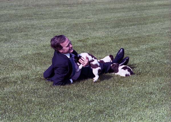 President Bush Plays with Millie and her Puppies on the Lawn of the White House 5 4 1989.