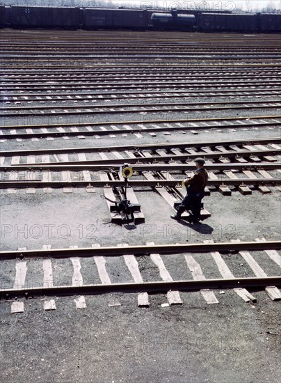 Switchman throwing a switch a C and NW RR's Proviso yard, Chicago, Ill. April 1943.