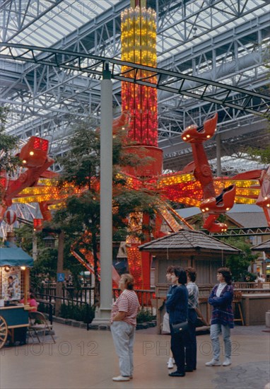 Women watch their children and grandchildren on a ride at the Mall of America circa 1994-1996.