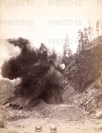 In mid air. A wonderful blast in building railroad to Deadwood 1890  .