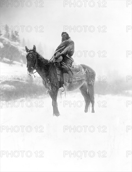 Edward S. Curtis Native American Indians -Apsaroke man on horseback on snow-covered ground, probably in Pryor Mountains, Montana circa 1908.