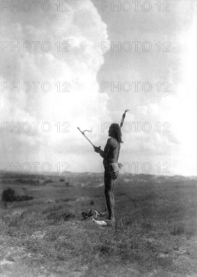 Edward S. Curits Native American Indians - Teton Sioux Indian performing vision cry ceremony through fasting and chanting to the Great Mystery circa 1907.