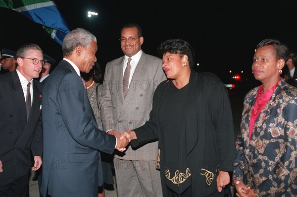 South Africa's president, Nelson Mandela, takes time to bid farewell to those waiting near by on the flight line prior to his departure..