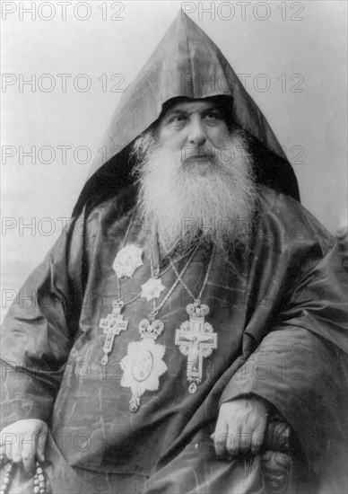 Patriarch Harootiun Vehabedian of the Armenian church wearing hood, robe and five medals, half-length portrait, facing right 1880-1924.