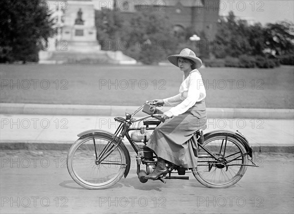 Woman riding bicycle in 1917 or 1918 .