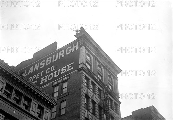 J. Reynolds Acrobat, performing acrobatic and balancing acts on top of building above 9th Street NW in Washington D.C. circa 1917.