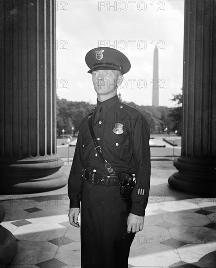 A U.S. Treasury Guard is displaying a new uniform for Treasury Officers circa 1937.