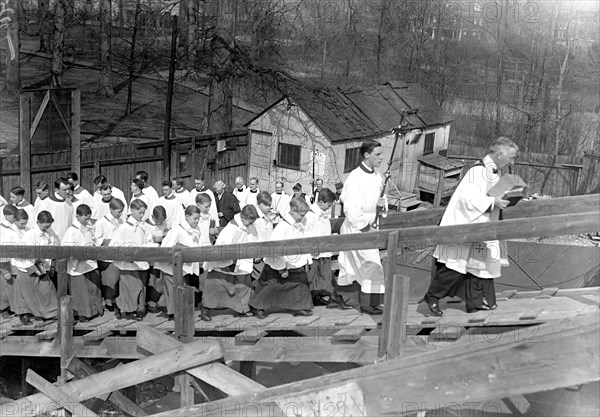 Catholic clergy and priests at outdoor religious service circa 1918.