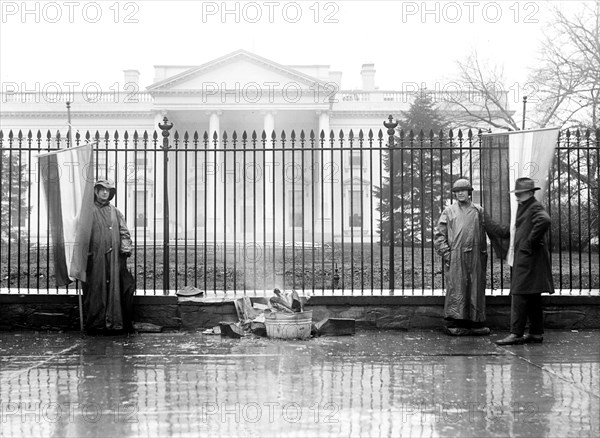 Woman Suffrage Movement - Bonfire on the sidewalk in front of the White House circa 1918 .