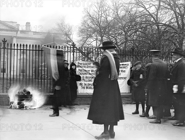 Woman Suffrage Movement - Bonfire on the sidewalk in front of the White House circa 1918 .