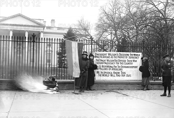 Woman Suffrage Movement - Bonfire on the sidewalk in front of the White House circa 1918 .