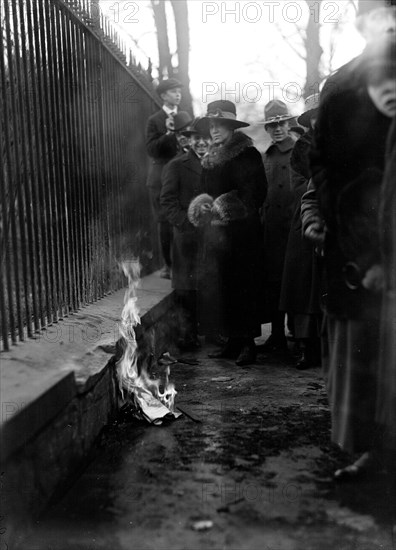 Woman Suffrage Movement - Bonfire on the sidewalk in front of the White House circa 1918 .