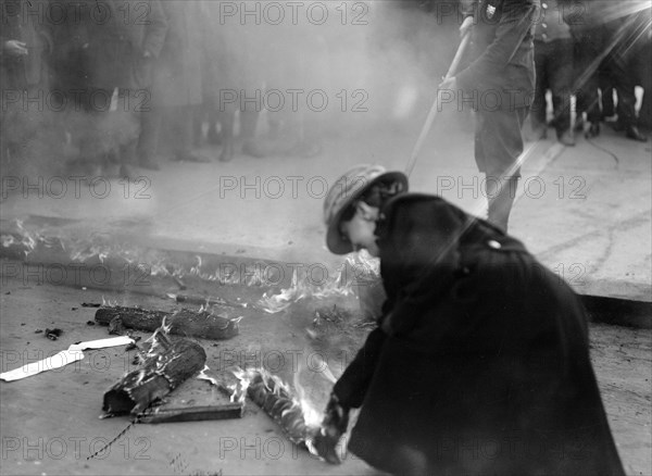 Woman Suffrage Movement - Bonfire on the sidewalk in front of the White House circa 1918 .