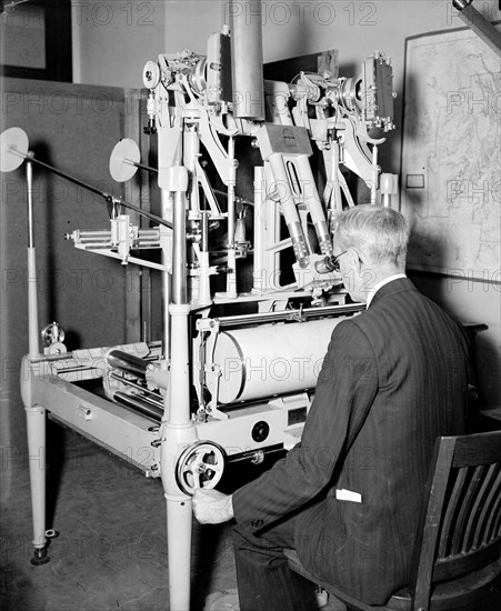 Geological Survey, Dept. Interior. Washington, D.C., Mar. 13. E.A. Shuster working with the erocartograph constructing topographies from airplane pictures circa 1937.