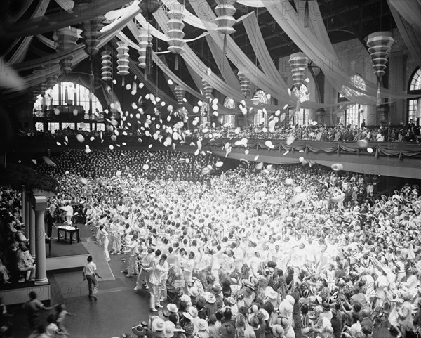 School's out for the graduating class at the Naval Academy at Annapolis, after receiving their diplomas the midshipmen are shown getting rid of their midshipmens caps for the headgear of an ensign. 6/3/37.