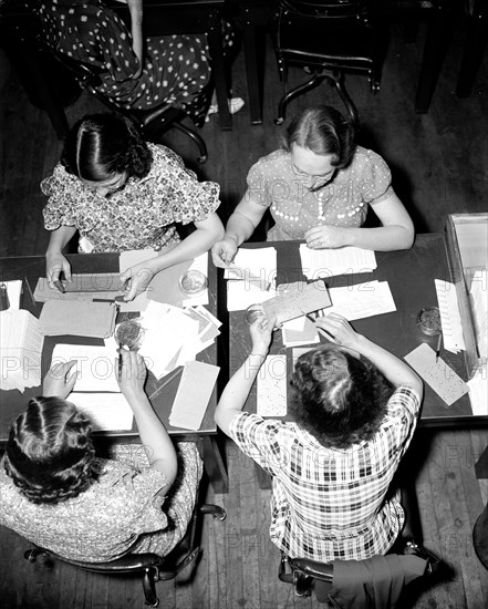 Social Security Board Records Office - Here the original application and the master card are brought together and checked for error. Checking is done by a team of two workers, and the few errors which have been made are corrected circa 1937.