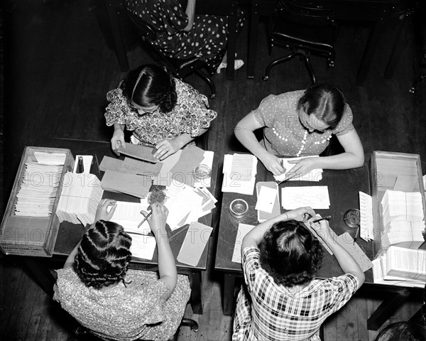 Social Security Board Records Office - Here the original application and the master card are brought together and checked for error. Checking is done by a team of two workers, and the few errors which have been made are corrected circa 1937.