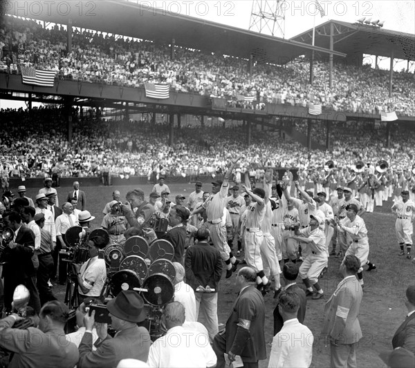 Players from both Major League All-Star teams stage a mad scramble to the first ball pitched by President Roosevelt to start the 1937 game today. Joe Moore, N.Y. Giants outfielder, caught the much coveted souvenir, 7/7/37.