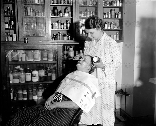 The department of Agriculture is making tests everyday in order to get cosmetics under the Pure Food and Drug Act, Mrs. C.W. West seated is helping Mrs. R. Goodman make a test on cold cream and other facial creams circa 1937.