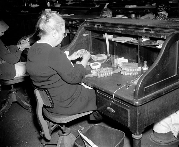 Counting currency at the Treasury Department  before destroying it because of old age circa 1937 .