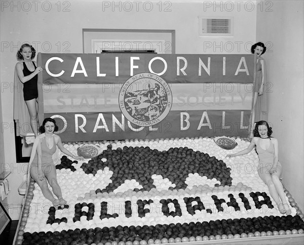 Women posing with California orange week festival ball display circa 1938.