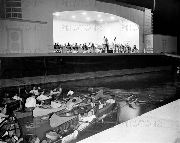 People in canoes listening to the National Symphony Orchestra circa 1938 .