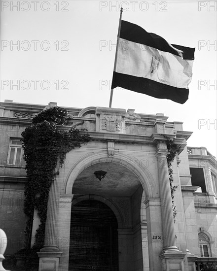 The flag of the Nationalist government flying over the Spanish Embassy here for the first time since the Franco Regime was recognized by the United States circa 1939.