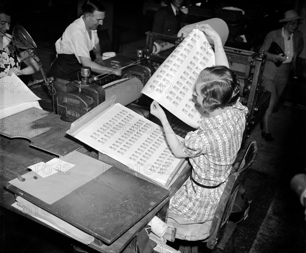 Imogene Stanhope, printer's assistant at the Bureau, is pictured pulling the first batch of U.S. government food stamps  off the press circa April 20, 1939.