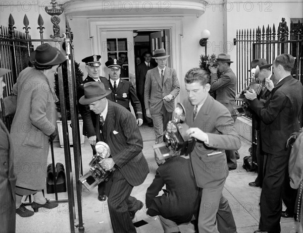 Camera-shy Col. Charles A. Lindbergh leaving the White House walking through Photographer's gauntlet circa April 20, 1939.