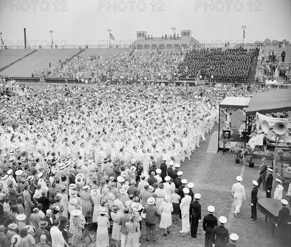 With a mighty heave graduates of the U.S. Naval Academy in Annapolis toss their midshipmen's caps into the air after receiving their commissions as ensigns circa 1939.