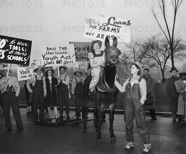 Anti-war protesters against World War II holding signs circa 1940 .