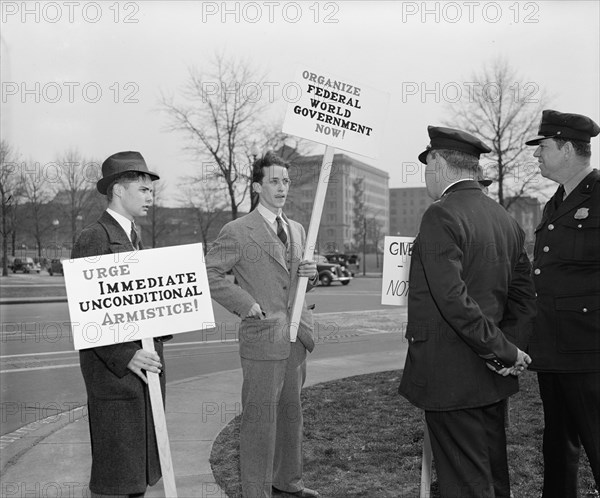 Washington police encounter anti-war protesters and one world government protesters holding signs circa 1940 .