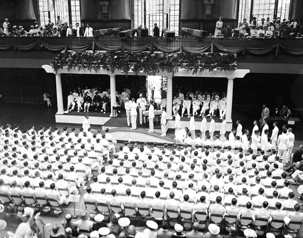 Annapolis graduation exercises - presenting diplomas to graduates circa 1936.