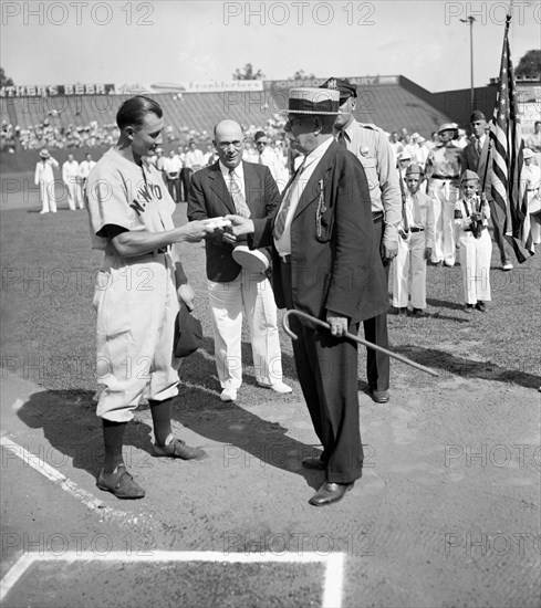 Jake Powell, New York Yankee outfielder, was presented with a wallet today as a token of esteem from fans of Laurel, MD, where he played as a semipro circa 1937.