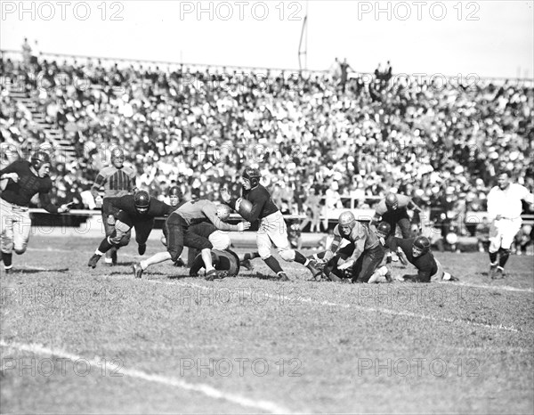 Running back Sneed Schmidt drives through the line in Navy's 18-6 defeat of William Mary to open the 1936 football season.