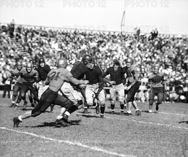 A Navy defensive back is tackled after intercepting a William & Mary pass 9/25/1936.