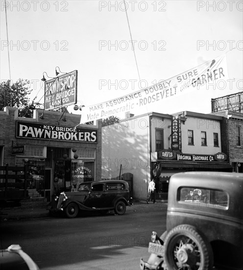 Photo shows one of the Roosevelt and Garner signs put up by the democratic party that hangs across a street in Rosslyn, Virginia circa ca. September 1936.