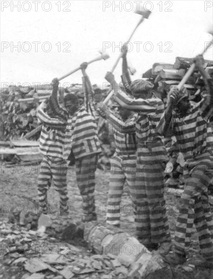 African American convicts working with axes, Reed Camp, South Carolina circa 1934.