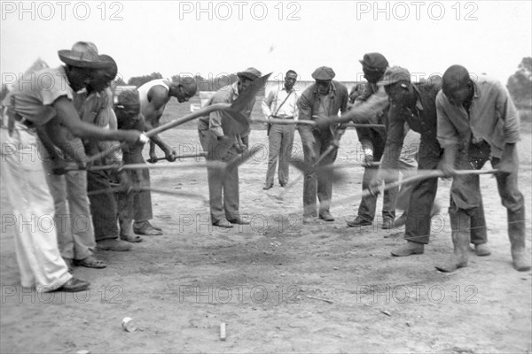 African American convicts working with shovels, possibly the singers of 'Rock Island Line' at Cummins State Farm, Gould, Arkansas, 1934.