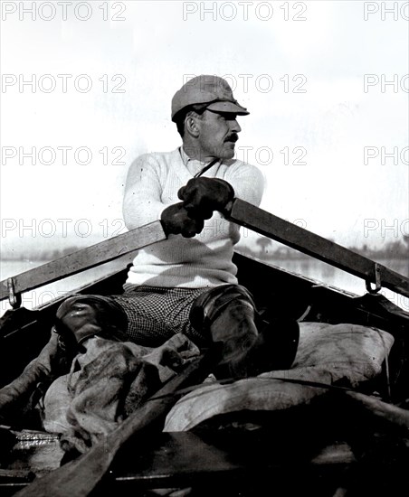 Man rowing a boat in the lake near Desoranto Ontairo circa 1909.