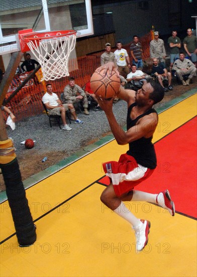 2006 - A U.S. Navy Information System's Technician Second Class, participates in a basketball slam dunk competition while assigned at Naval Computer Telecommunications Area Master Station, Atlantic, Detachment Djibouti. .