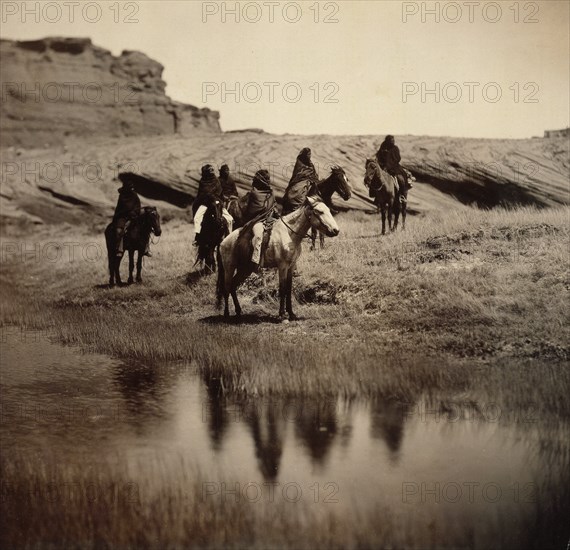 Edward S. Curits Native American Indians - Six Navajo on horseback, water in foreground circa 1904.