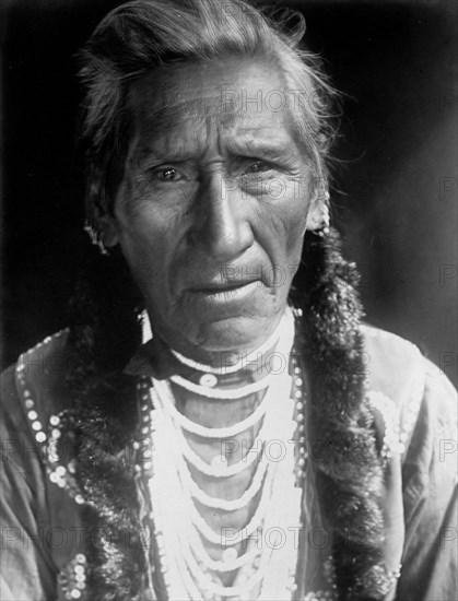 Edward S. Curits Native American Indians - Photograph shows Flathead man, head-and-shoulders portrait, facing front circa 1910.