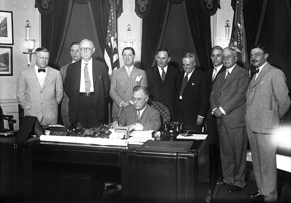 Franklin D. Roosevelt - President Roosevelt signs small home loan measure. President Roosevelt today signed the bill providing for a $2,000,000,000 refinancing of small home mortgages to put them on lower interest rates circa 1933.