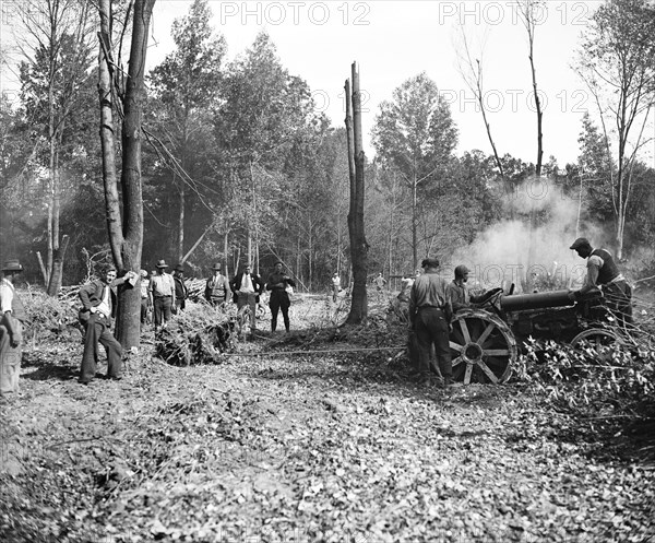 This crew of swampers is busy clearing out trees and stumps to make a place for the erection of a new town by the government, popularly termed 'Tugwelltown' a.k.a. Greenbelt Maryland circa October 15 1935.