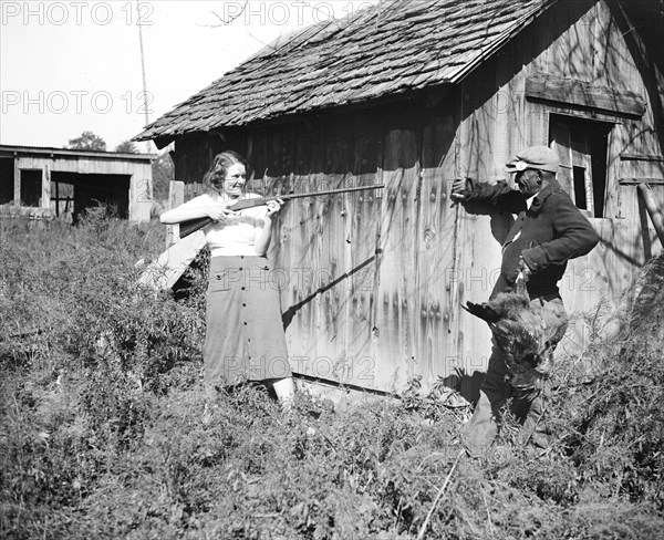 Edna Morris, who lives within a few hundred feet of the government-owned 'Tugwelltown' being constructed near Washington by Rehabilitation Administration, arms herself to protect her property against what she termed the 'thieving' of the workers on the project circa 10/15/1935.