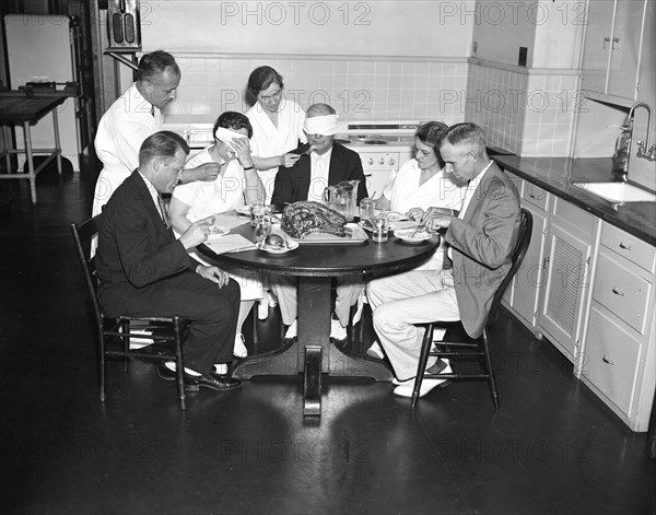 Blindfolded man and woman are part of a Meat testing experiment at the U.S. Department of Agriculture circa 1936.