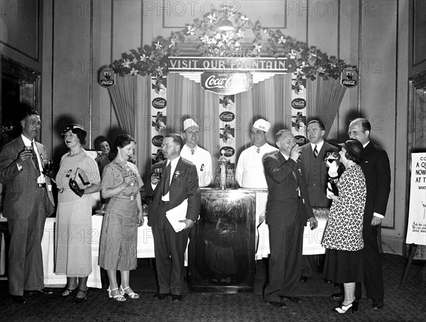 Coca-Cola display and people drinking coca-cola circa 1934.