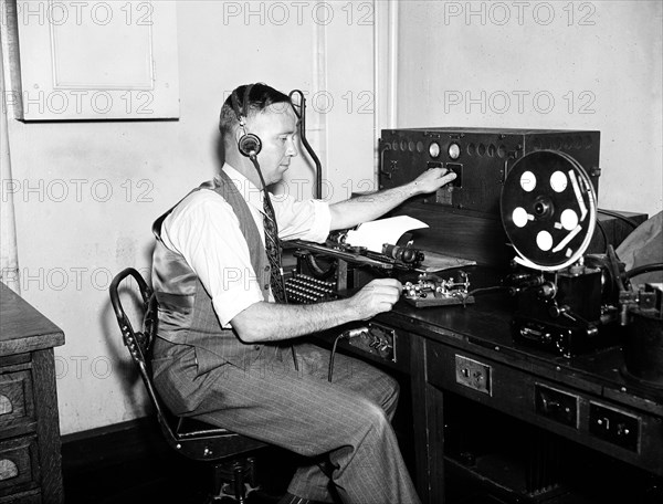 Man listening to radio circa 1936.