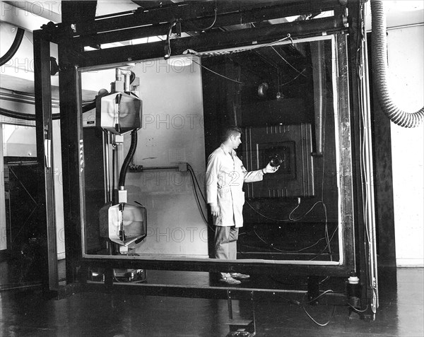 Jay Prendergast adjusts the lens on a Robertson 48-inch, 4.5 ton camera. Installed in 1959, the camera was used for precise scale transformation of mapping separates and composites. This photo was taken in Menlo Park, CA in 1965..